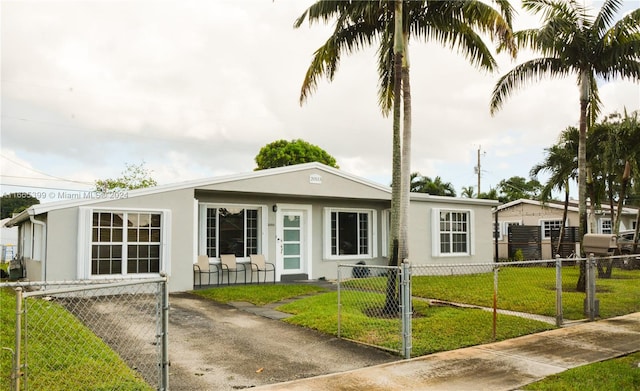 single story home featuring a front lawn