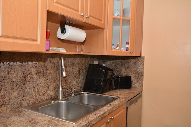 kitchen with dishwasher, tasteful backsplash, and sink