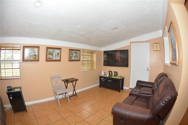 tiled living room featuring a healthy amount of sunlight, a textured ceiling, lofted ceiling, and ornamental molding