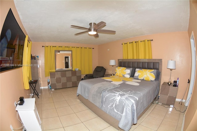 tiled bedroom featuring ceiling fan and a textured ceiling