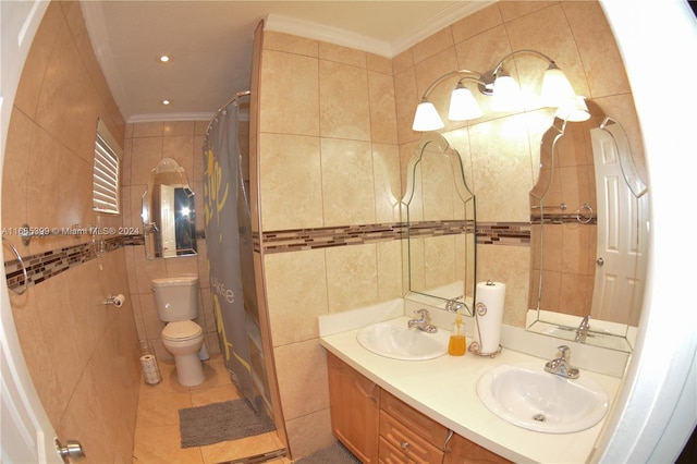 bathroom featuring toilet, crown molding, vanity, and tile walls