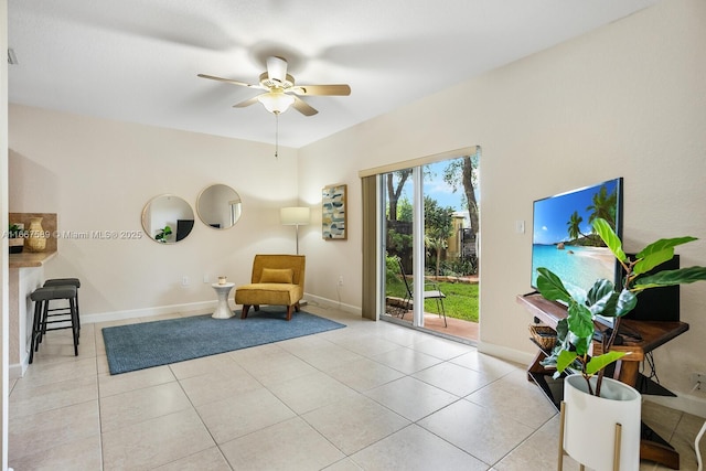 sitting room featuring ceiling fan and light tile patterned floors