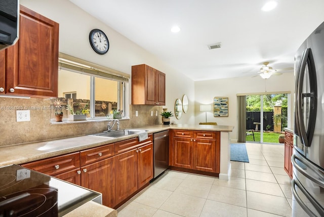 kitchen with backsplash, sink, ceiling fan, appliances with stainless steel finishes, and kitchen peninsula