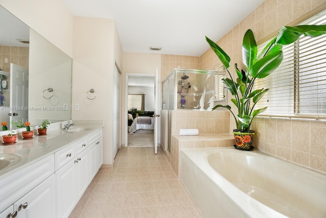 bathroom with tile patterned flooring, vanity, and shower with separate bathtub