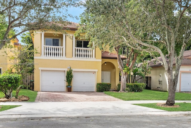 mediterranean / spanish-style house with a balcony, a garage, and a front lawn