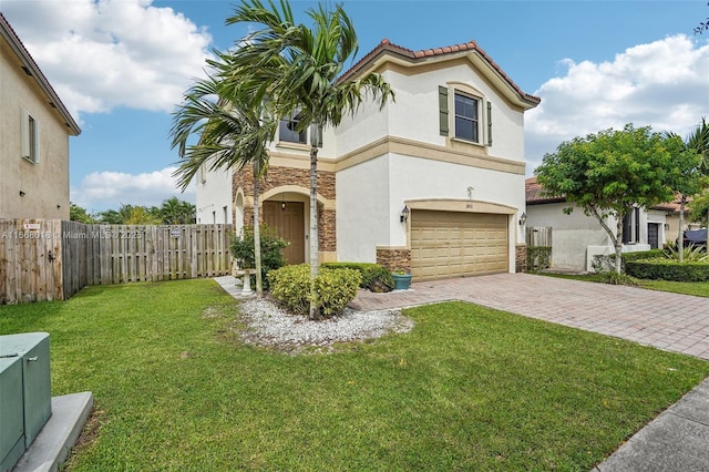 mediterranean / spanish home featuring stone siding, stucco siding, fence, decorative driveway, and a front yard