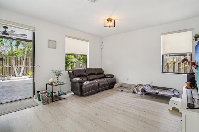 living room with light wood finished floors and ceiling fan