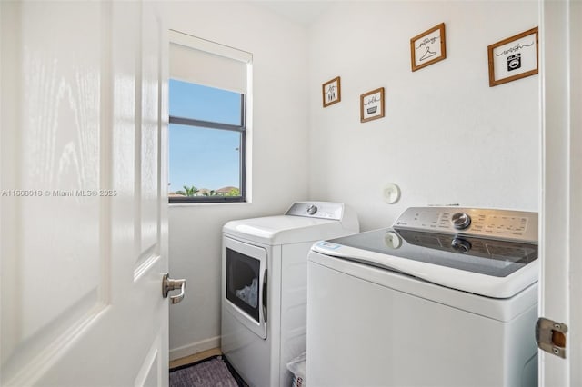 clothes washing area featuring laundry area and washer and clothes dryer