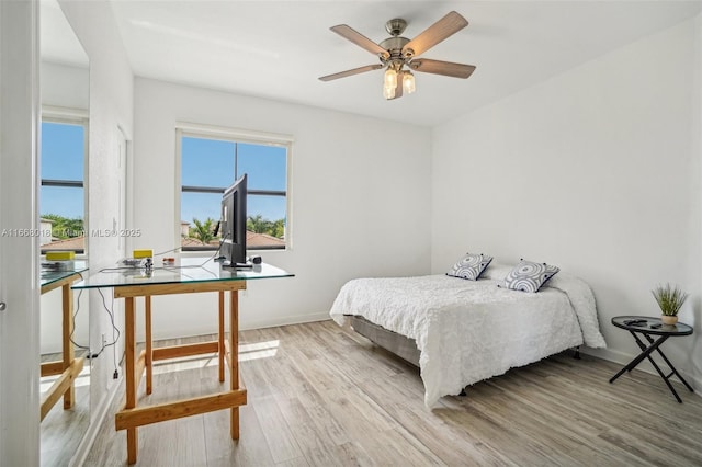 bedroom featuring baseboards and light wood-style floors