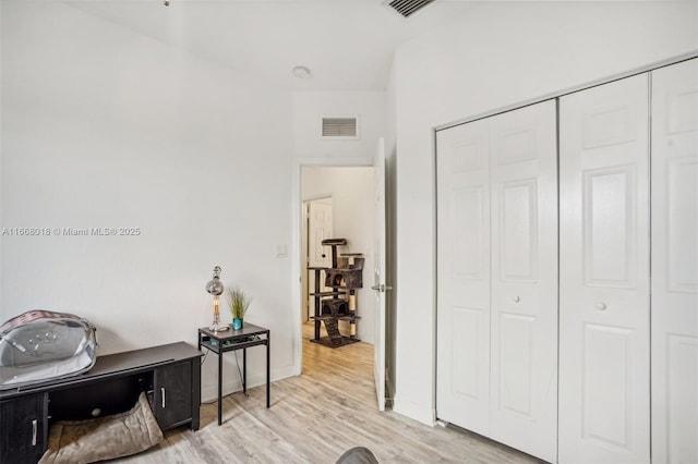 interior space featuring light wood finished floors, visible vents, and baseboards