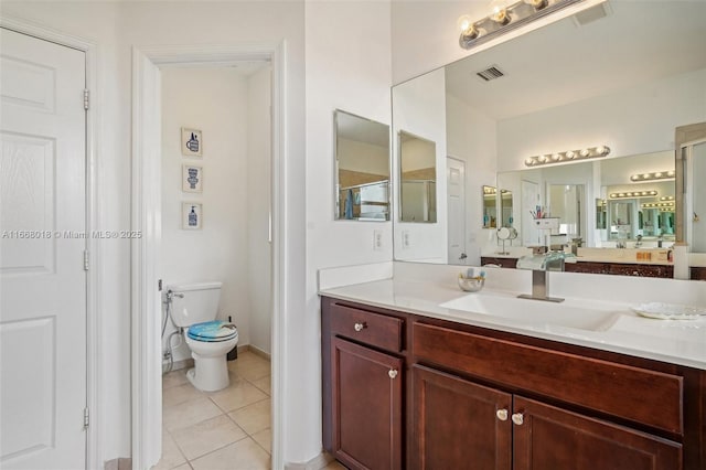 bathroom with toilet, tile patterned flooring, visible vents, and vanity