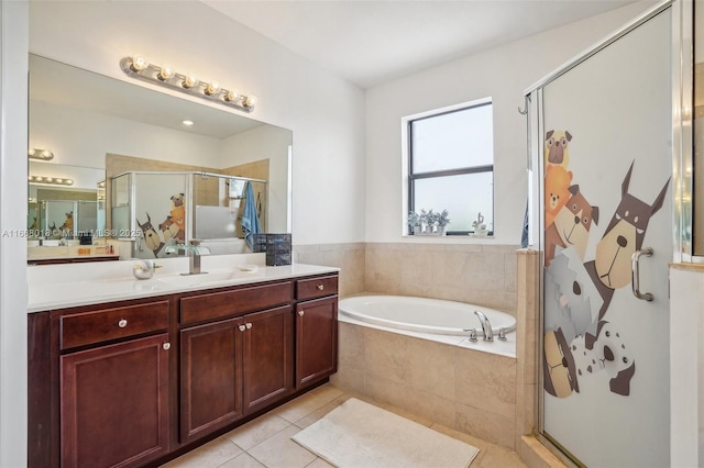 full bath with a stall shower, tile patterned flooring, a bath, and vanity