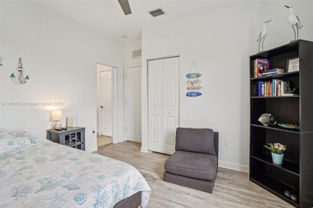 bedroom featuring a closet, visible vents, and light wood-style floors