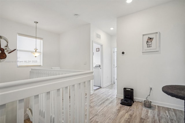 corridor featuring recessed lighting, visible vents, light wood-style flooring, and baseboards