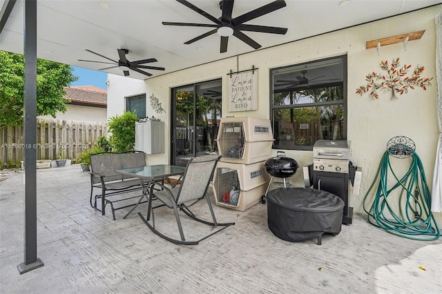 view of patio featuring ceiling fan, fence, outdoor dining area, and area for grilling