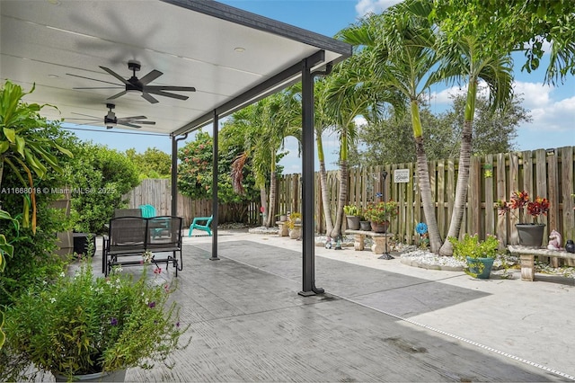 view of patio featuring ceiling fan, outdoor dining area, and a fenced backyard