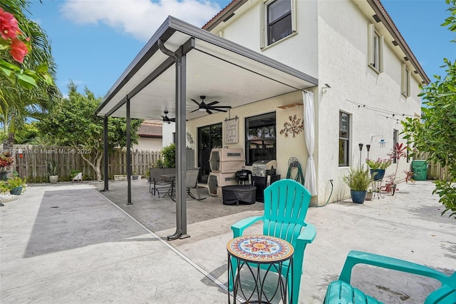 view of patio featuring ceiling fan and fence