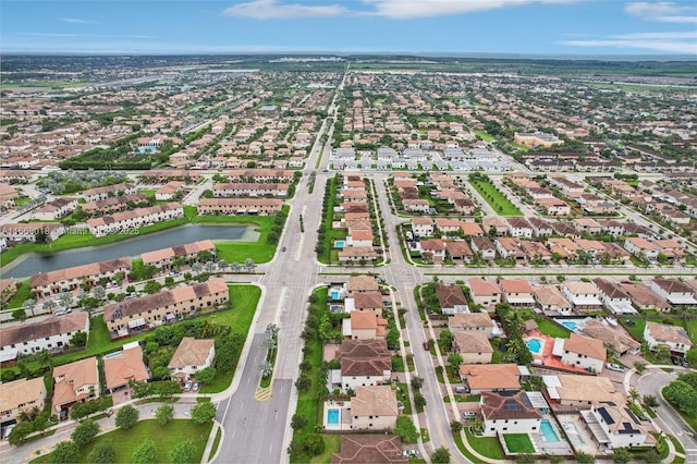 birds eye view of property featuring a water view and a residential view