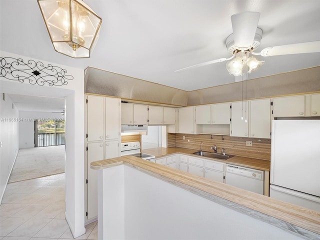 kitchen featuring white appliances, white cabinetry, light tile patterned floors, and pendant lighting