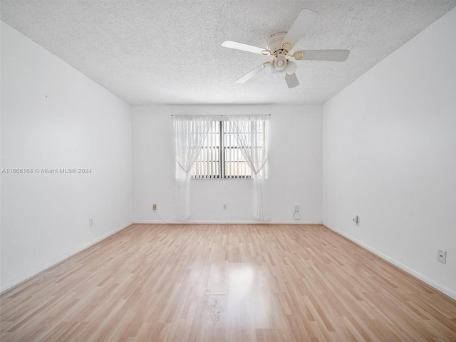 unfurnished room with a textured ceiling, ceiling fan, and light hardwood / wood-style flooring