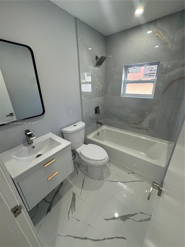 full bathroom featuring vanity, tiled shower / bath combo, and toilet