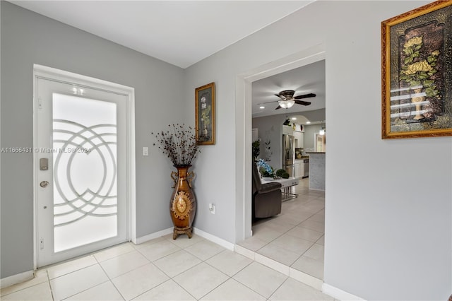 entryway with light tile patterned flooring and ceiling fan