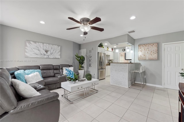 tiled living room with ceiling fan