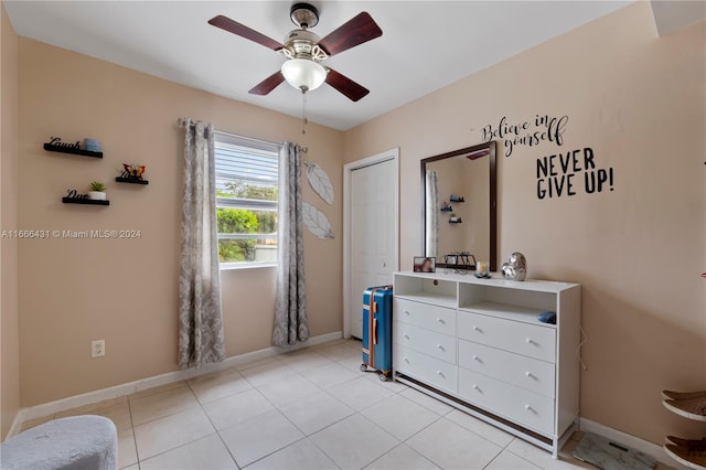 tiled bedroom featuring ceiling fan