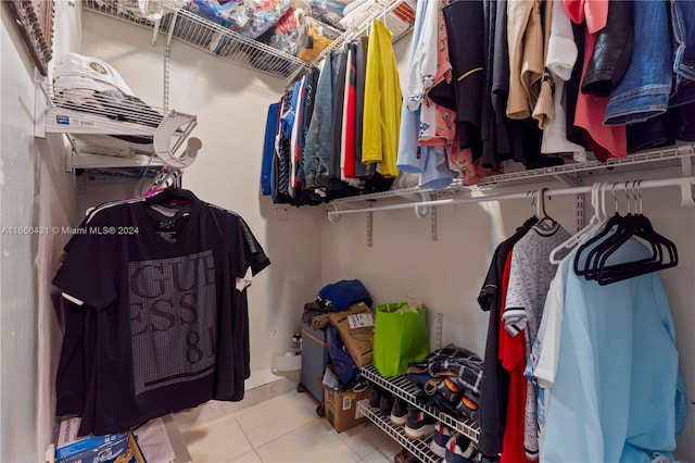 spacious closet with light tile patterned floors