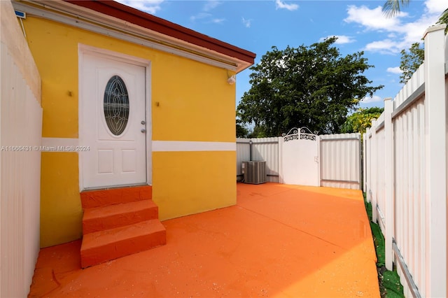 view of exterior entry featuring central air condition unit