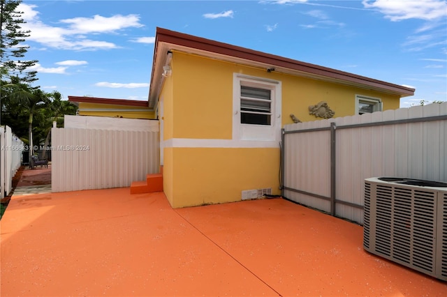 view of property exterior with a patio and central air condition unit