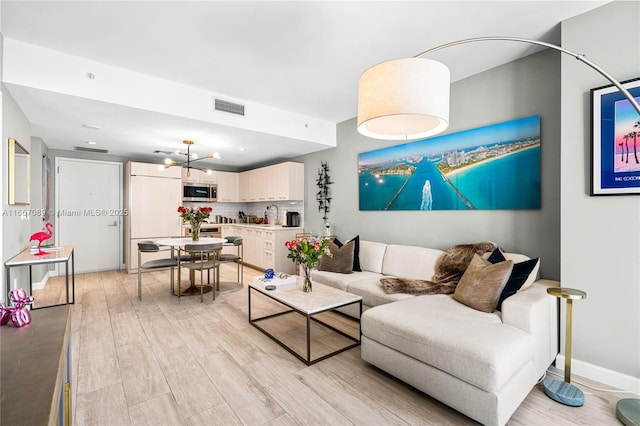 45 SW 9th St Unit 4007, Miami, FL 33130 - living room with light wood-style flooring and a chandelier