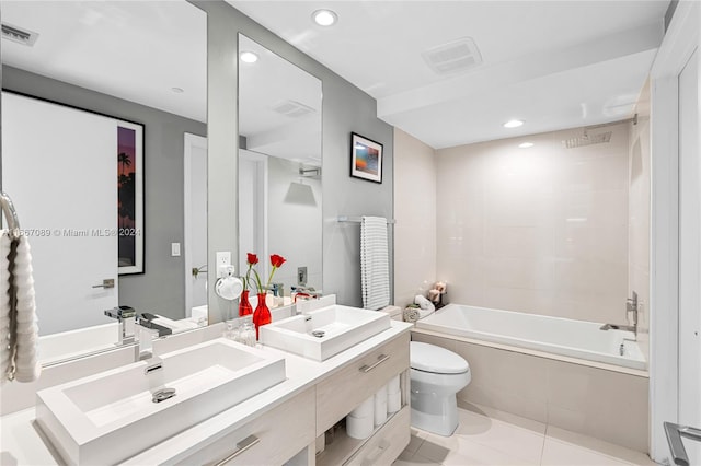 full bathroom with vanity, tiled shower / bath combo, toilet, and tile patterned flooring