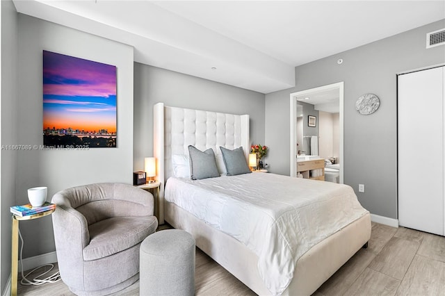 45 SW 9th St Unit 4007, Miami, FL 33130 - bedroom with wood finished floors, baseboards, and ensuite bath