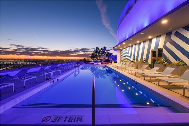 view of pool at dusk