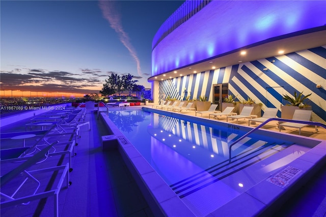 view of pool at dusk