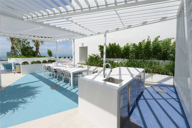 view of swimming pool featuring a pergola, a patio, and a bar