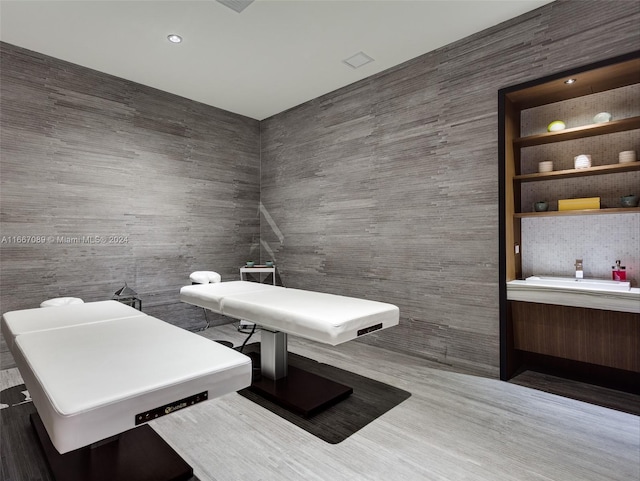 miscellaneous room featuring hardwood / wood-style flooring and sink