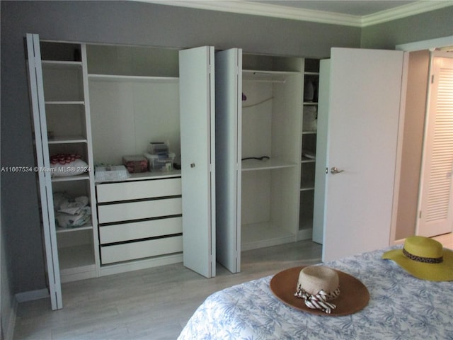 bedroom featuring ornamental molding and light hardwood / wood-style floors