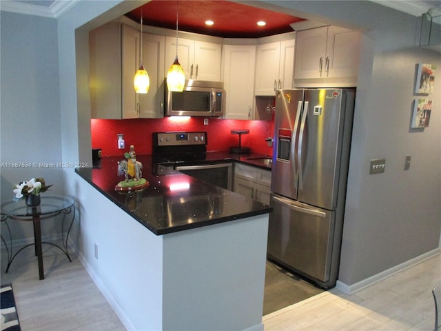 kitchen featuring pendant lighting, white cabinets, kitchen peninsula, and appliances with stainless steel finishes