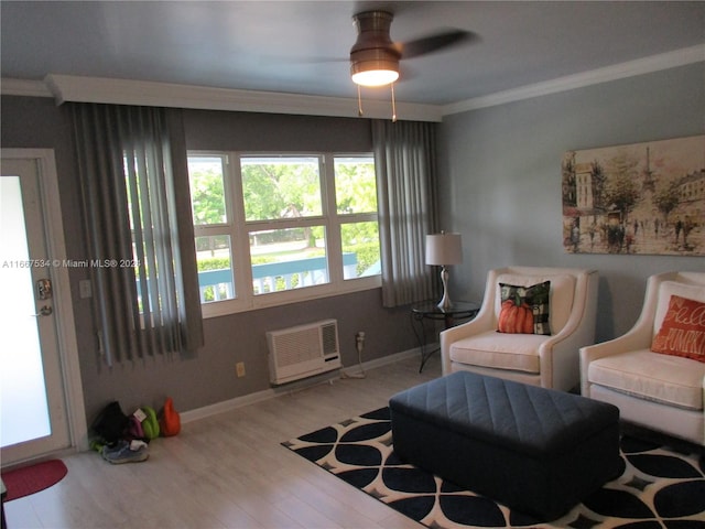 sitting room featuring ceiling fan, light hardwood / wood-style flooring, ornamental molding, and a wall mounted AC