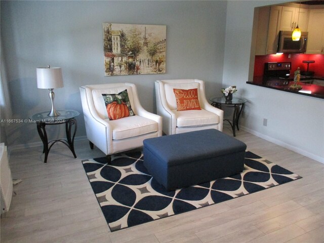 living area with light hardwood / wood-style flooring