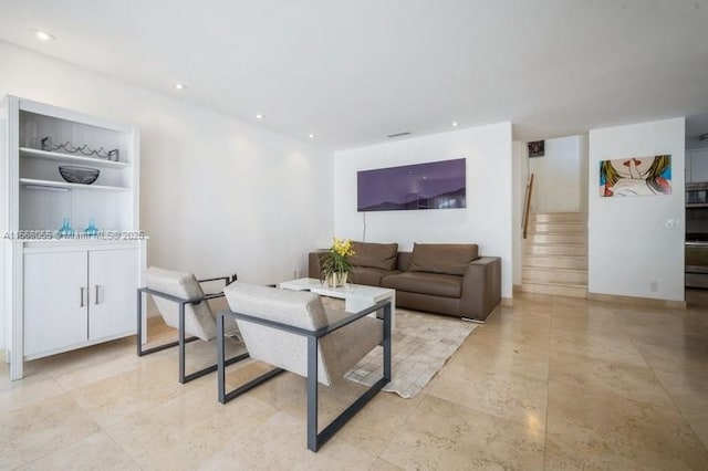 living area featuring recessed lighting and stairs