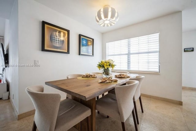 dining room featuring light tile patterned flooring and baseboards