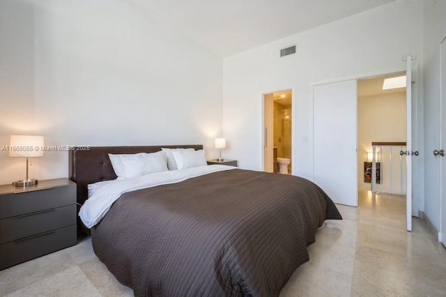 bedroom with ensuite bathroom and visible vents