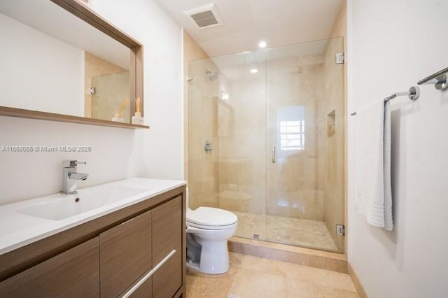 bathroom with toilet, a stall shower, vanity, and visible vents