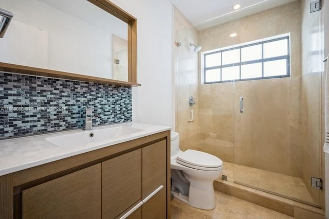 full bathroom featuring vanity, backsplash, toilet, and a shower stall