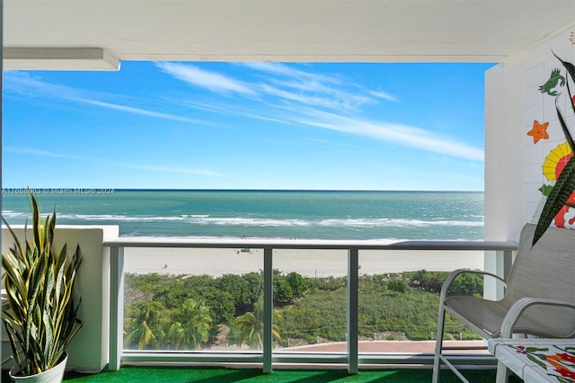 balcony with a water view and a beach view