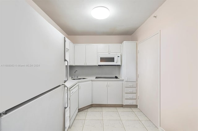 kitchen featuring white appliances, sink, and white cabinets