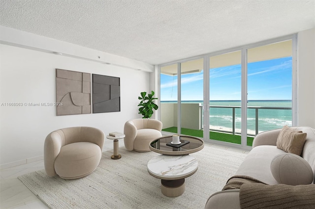 living room with a water view and a textured ceiling